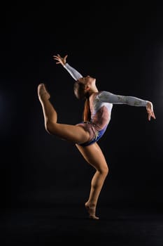 Fashion girl ballet dancer. Sport gymnastics studio shot on a white and black background