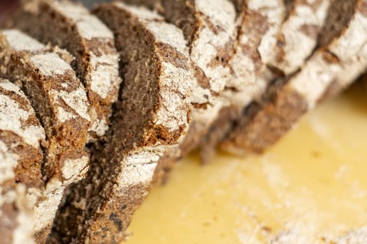 close-up view of some freshly cut slices of whole grain rye bread. Whole grain rye bread is made from all parts of the rye grain and has potential health benefits.