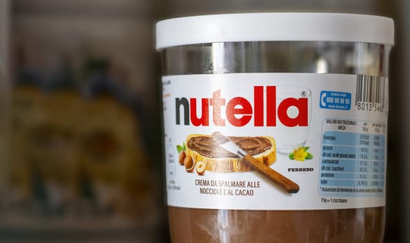 Rome, IT, July 2 2023: Close-up of a jar of Nutella on a shelf. Nutella is a famous brand of hazelnut and cocoa spread. It is known for its authentic taste and distinctive creaminess. Illustrative editorial