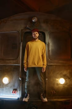Breakdancer hipster b-boy standing at urban subway train. Contemporary freestyle dance performance concept
