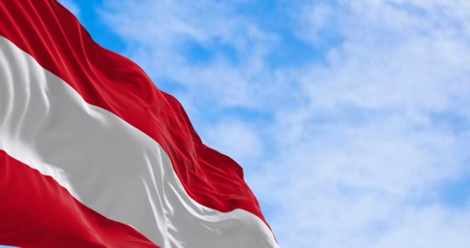 The national flag of Austria waving on a clear day. Three equal horizontal bands: white, red upper & lower, middle band. 3d illustration render. Selective focus. Rippled fabric.