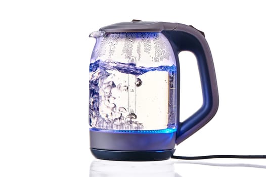 Glass electric kettle with boiling water on a white insulated background. High quality photo