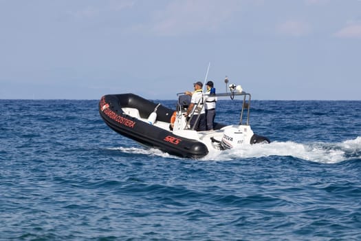 FIUMEFREDDO DI SICILIA, SICILY, ITALY - AUGUST 12, 2022  Coast Guard patrolling with a lifeboat near the coast of Sicily in the Mediterranean Sea