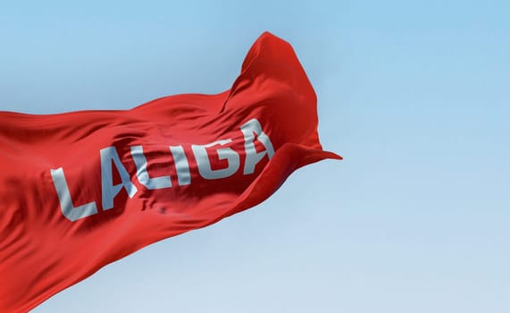 Madrid, SPA, July 10 2023: La Liga flag waving on a clear day. La Liga is the top professional football division of the Spanish football league system. Illustrative editorial 3d illustration render