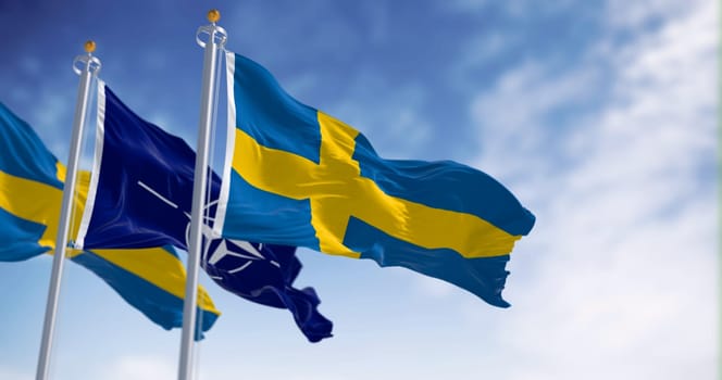 Brussels, BL, July 10 2023: The flags of Sweden and NATO waving in the wind. Sweden and NATO have a close relationship. Illustrative editorial 3d illustration render