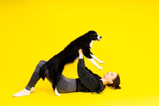 Woman walks and getting exercise for both herself and her border collie dog.