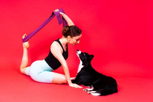 Woman walks and getting exercise for both herself and her border collie dog.