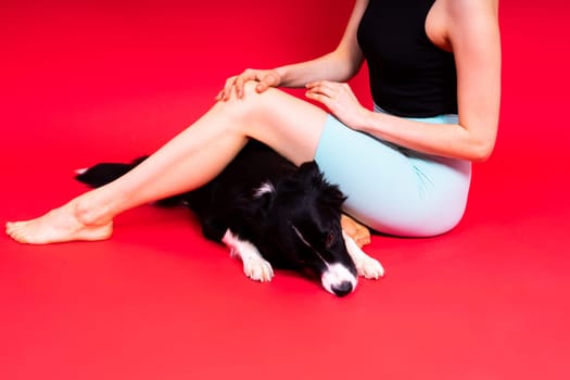Woman walks and getting exercise for both herself and her border collie dog.