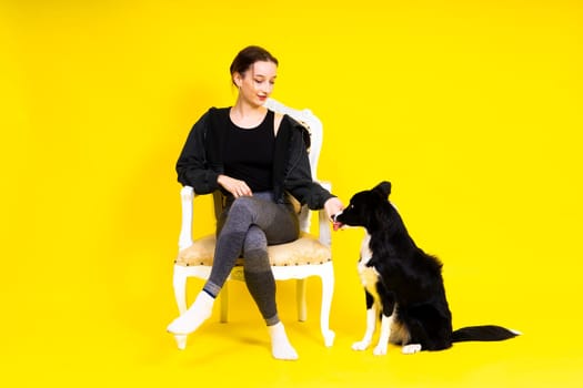 Woman walks and getting exercise for both herself and her border collie dog.