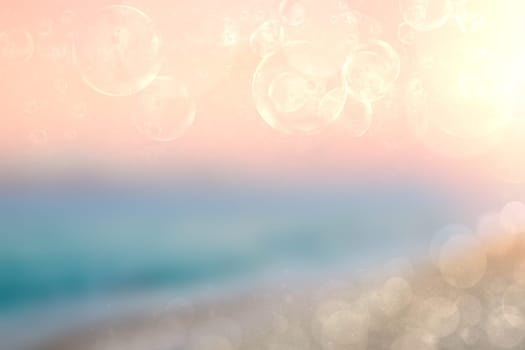 Abstract sea background. Abstract tropical sandy summer beach background with bokeh lights on light blueorange sky and sun. Beautiful texture. Space.