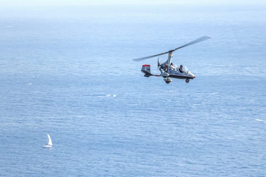 Taormina, Sicily, Italy - August 7, 2022 Leisure flight with Autogiro on the coast of Taormina in the Mediterranean Sea