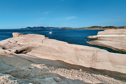Beautiful landscape of white rocks of Sarakiniko beach, Aegean sea, Milos island , Greece. Empty cliffs, summer day sunshine, clear sea, blue waters, no people, beautiful landscape, fantastic rocks of tourist destination.