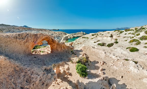 Beautiful landscape of famous white rocks, Sarakiniko beach, Aegean sea, Milos island , Greece. No people, empty cliffs, summer day sunshine, clear sea, blue waters, azure lagoon, fantastic rocks of tourist destination.