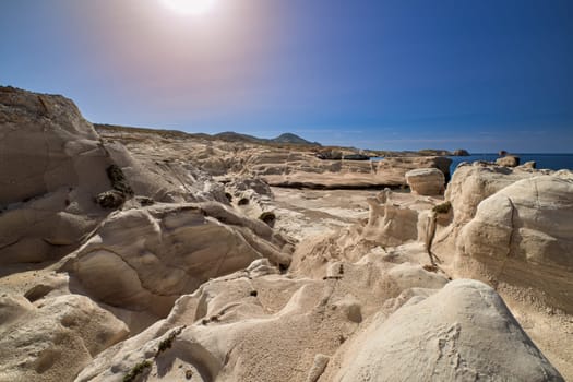 Famous white rocks of Sarakiniko beach, Aegean sea, Milos island , Greece. No people, empty cliffs, summer day sunshine, clear blue sky, beautiful landscape, fantastic rocks of tourist destination.