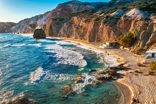 Beautiful sunset view of Fyriplaka beach, Milos island, Greece. Greek vacations, Aegean sea, high rocky landscape, azure waters, sandy beach, unique location of traditional tourist destination,