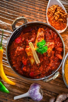 Composition with indian dishes: madras paneer, palak paneer and shahi paneer with basmati rice served in original indian karahi pots.