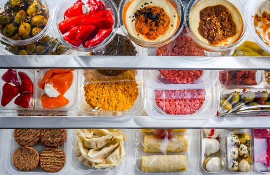 A display of variety of prepackaged food products in plastic boxes.