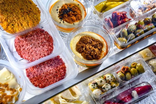 A display of variety of prepackaged food products in plastic boxes.