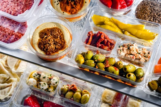 A display of variety of prepackaged food products in plastic boxes.