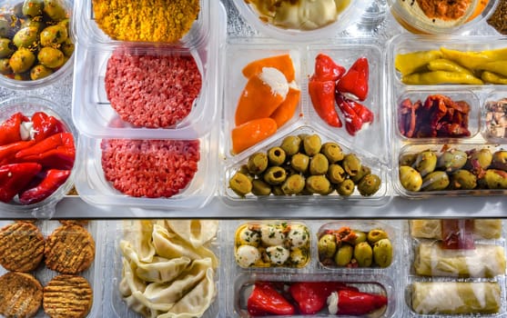 A display of variety of prepackaged food products in plastic boxes.