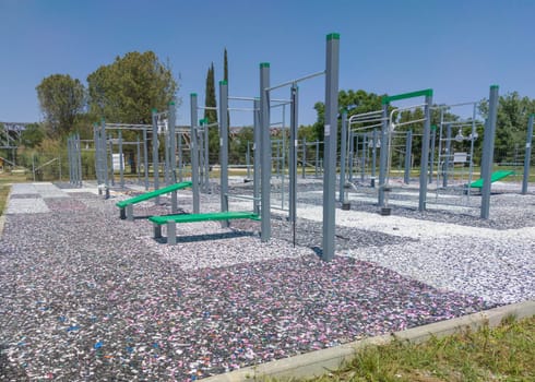 Calisthenics park floor made from recycled rubber particles. Outdoors daylight shot