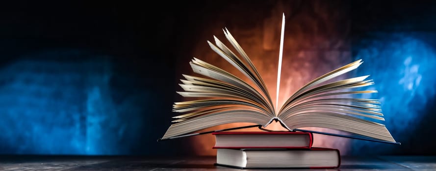 A composition with an open book lying on a stack of other books