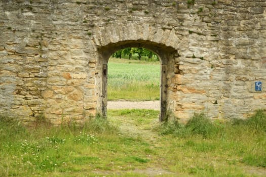 Fields and meadows through a historic wall