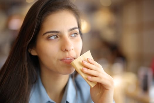 Restaurant customer cleaning mouth with paper tissue looking away