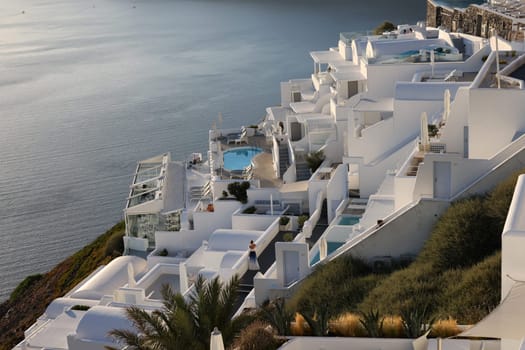 Imerovigli, Santorini, Greece - June 29, 2021: Whitewashed houses with terraces and pools and a beautiful view in Imerovigli on Santorini island, Greece