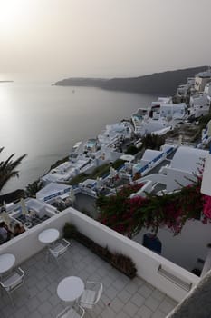 Imerovigli, Santorini, Greece - July 1, 2021: Whitewashed houses with terraces and pools and a beautiful view in Imerovigli on Santorini island, Greece