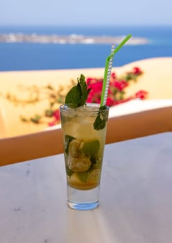 Mojito cocktail in a glass with a straw