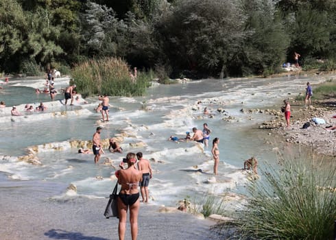 Saturnia, Italy - September 13, 2022:  People are bathing in the hot springs of Saturnia Therme, Saturnia, Tuscany, Italy