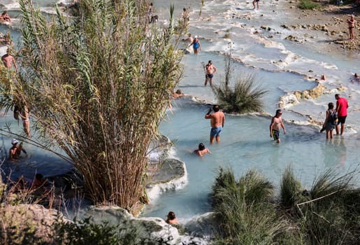Saturnia, Italy - September 13, 2022:  People are bathing in the hot springs of Saturnia Therme, Saturnia, Tuscany, Italy