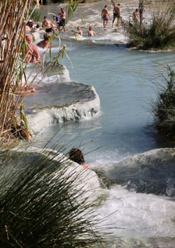 Saturnia, Italy - September 13, 2022:  People are bathing in the hot springs of Saturnia Therme, Saturnia, Tuscany, Italy