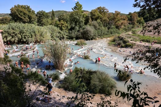 Saturnia, Italy - September 13, 2022:  People are bathing in the hot springs of Saturnia Therme, Saturnia, Tuscany, Italy