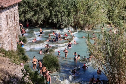 Saturnia, Italy - September 13, 2022:  People are bathing in the hot springs of Saturnia Therme, Saturnia, Tuscany, Italy