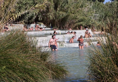 Saturnia, Italy - September 13, 2022:  People are bathing in the hot springs of Saturnia Therme, Saturnia, Tuscany, Italy