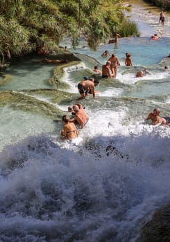 Saturnia, Italy - September 13, 2022:  People are bathing in the hot springs of Saturnia Therme, Saturnia, Tuscany, Italy