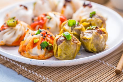 Assortment of steamed dumplings Dim Sum on kitchen table
