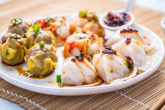 Assortment of steamed dumplings Dim Sum on kitchen table