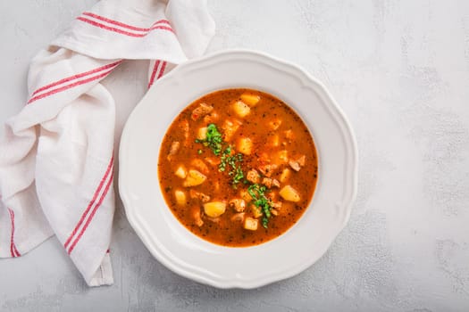 Hungarian hot goulash soup, beef, tomato, pepper, chili, smoked paprika soup. Traditional Hungarian dish.