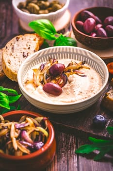 Whipped feta cheese dip with garlic, olives, lemon and caramelized onions. Greek cuisine concept, Tirokafteri dip.