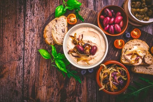 Whipped feta cheese dip with garlic, olives, lemon and caramelized onions. Greek cuisine concept, Tirokafteri dip.