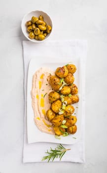 Whipped feta, ricotta, cheese dip (Tirokafteri) with crispy baked potatoes and grilled olives