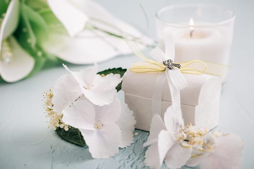 Confirmation or First holy communion concept - small present with candle and flowers
