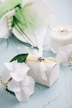 Confirmation or First holy communion concept - small present with candle and flowers