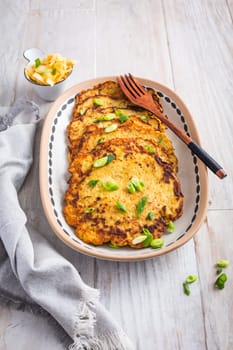Homemade potato pancakes (Kartoffelpuffer) with cabbage salad and green onions