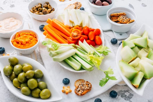Crudites platter, raw vegetarian food or party vegetarian platter with various veggie snacks and dips