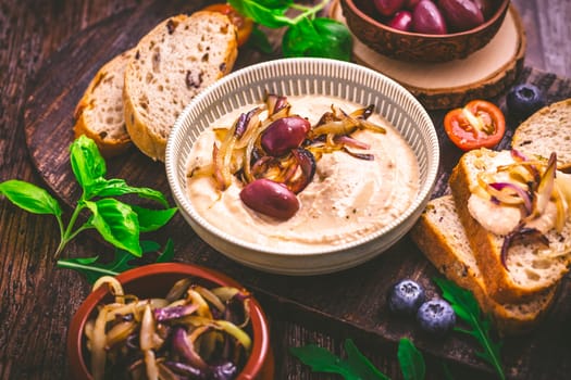 Whipped feta cheese dip with garlic, olives, lemon and caramelized onions. Greek cuisine concept, Tirokafteri dip.
