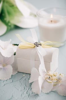 Confirmation or First holy communion concept - small present with candle and flowers